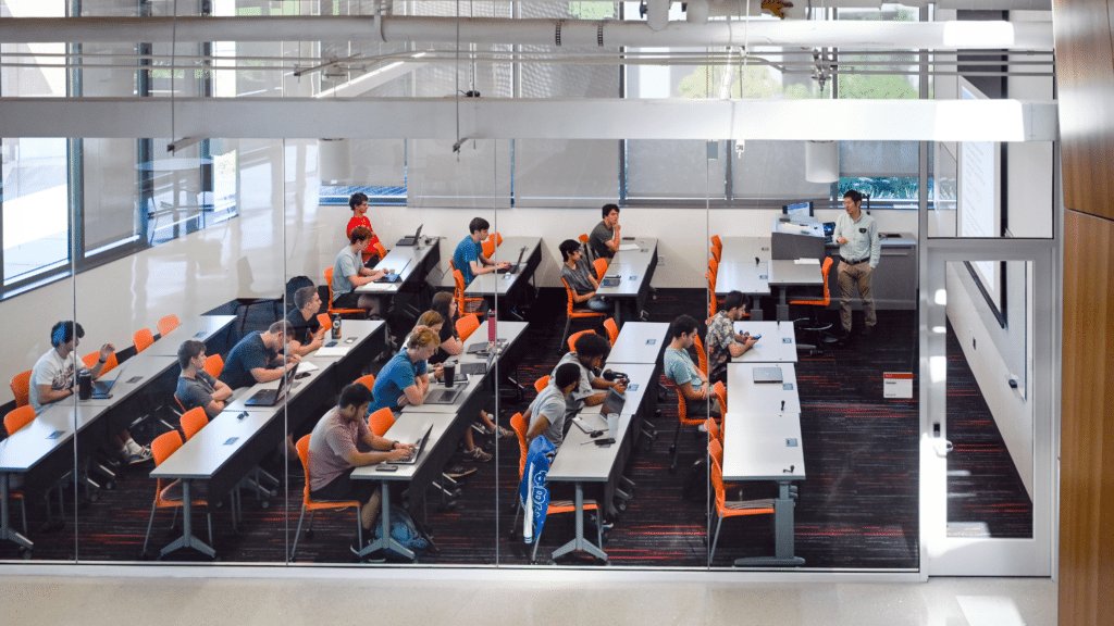 Students sit in a classroom with an instructor leading class.
